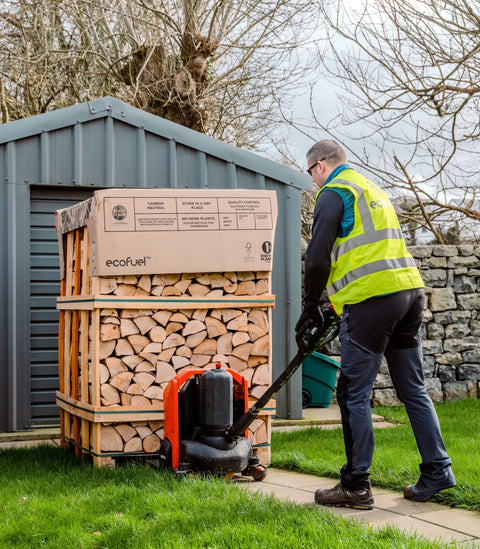 ECOFUEL™ DoubleDeck® kiln dried firewood crate being moved by pallet truck during home delivery.