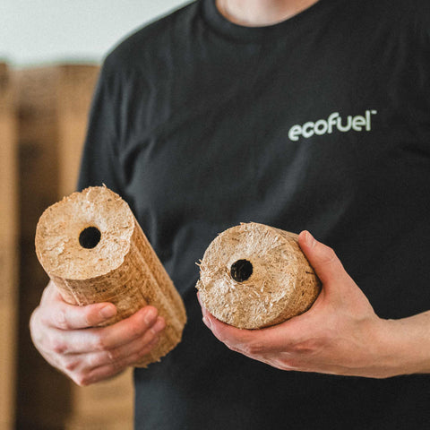 Close-up of ECOFUEL™ EcoBriquettes showing dense hardwood texture and center core for efficient burning