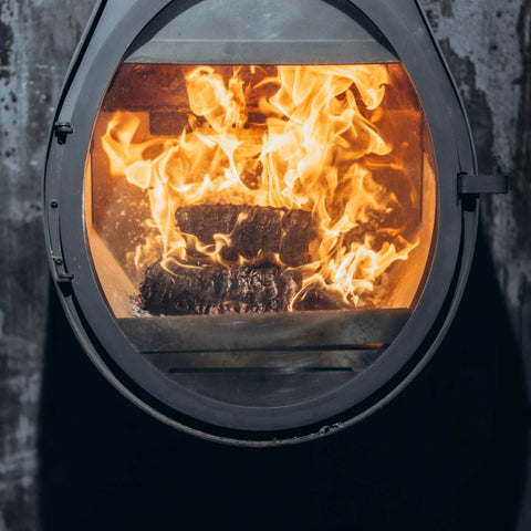 ECOFUEL™ EcoBriquettes burning clean in stove, delivering intense heat and low-emission performance