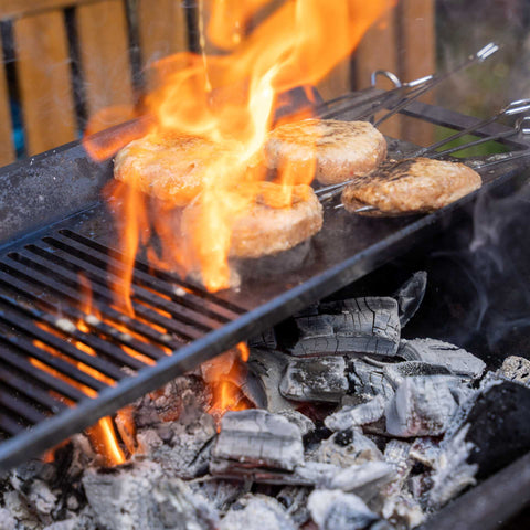 Open flame BBQ grilling over ECOFUEL™ Organic Lumpwood Charcoal showing intense heat and real wood fire