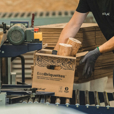 Ecofuel team member handling eco-friendly ecobriquettes by ECOFUEL with a focus on sustainability.